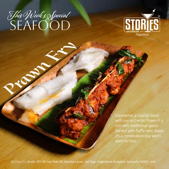 Prawn fry on a banana leaf with neer dosas on a copper platter – "This Week's Special" seafood poster for Stories Bar & Kitchen, Nagarbhavi