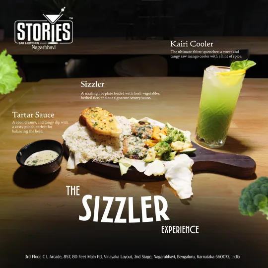 Vegetable sizzler with herbed rice and garlic bread, tartar sauce and a green Kairi Cooler – "The Sizzler Experience" poster for Stories Bar & Kitchen, Nagarbhavi
